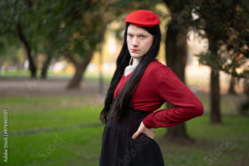 Transgender woman posing sensually in a park