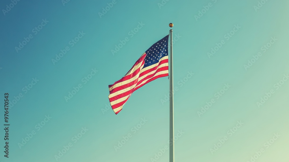 American Flag Pole Blowing in Wind with Blue Sky Background. America Independence Day July 4th Holiday American Flag Pole Blowing in Wind with Blue Sky Background. America Independence Day July 4th Holiday