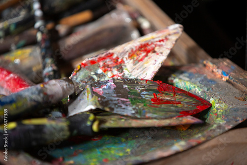 Paint brushes and palette with red, yellow, blue and green paint