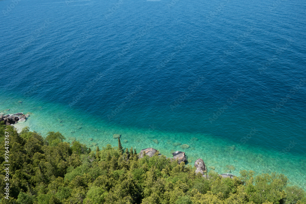 Aerial View of Clear Blue Coastline with Lush Green Forest Aerial View of Clear Blue Coastline with Lush Green Forest