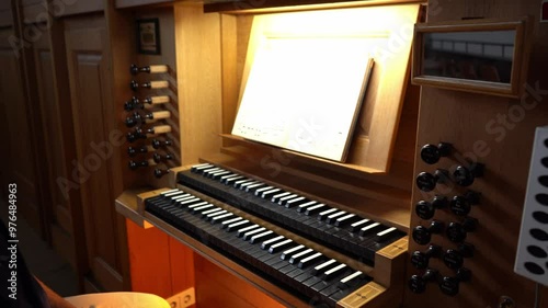 Organist turning on the organ in a Catholic Church.