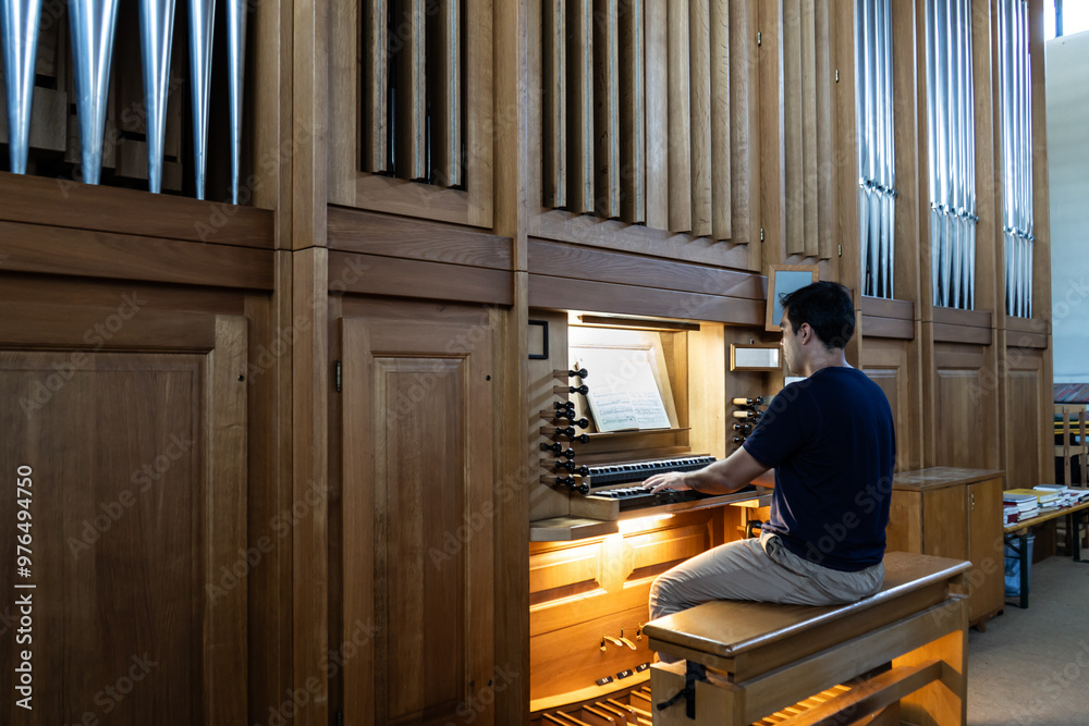Left side view of organist playing organ in Catholic Church. Left side view of organist playing organ in Catholic Church.