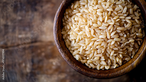 close-up of uncooked brown rice grains in a rustic wooden bowl photo