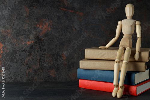 Books with a wooden man on a dark background