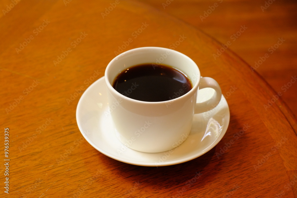 cup of coffee on wooden table cup of coffee on wooden table