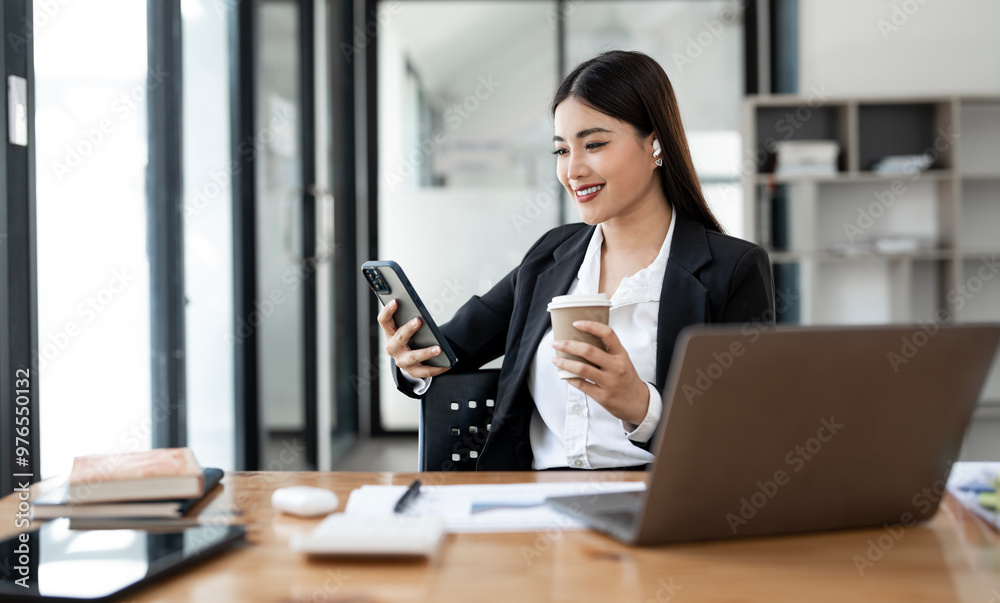 Portrait of young Asian businesswoman in suit, woman smiling using mobile phone and work at workplace inside office, Portrait of young Asian businesswoman in suit, woman smiling using mobile phone and work at workplace inside office,