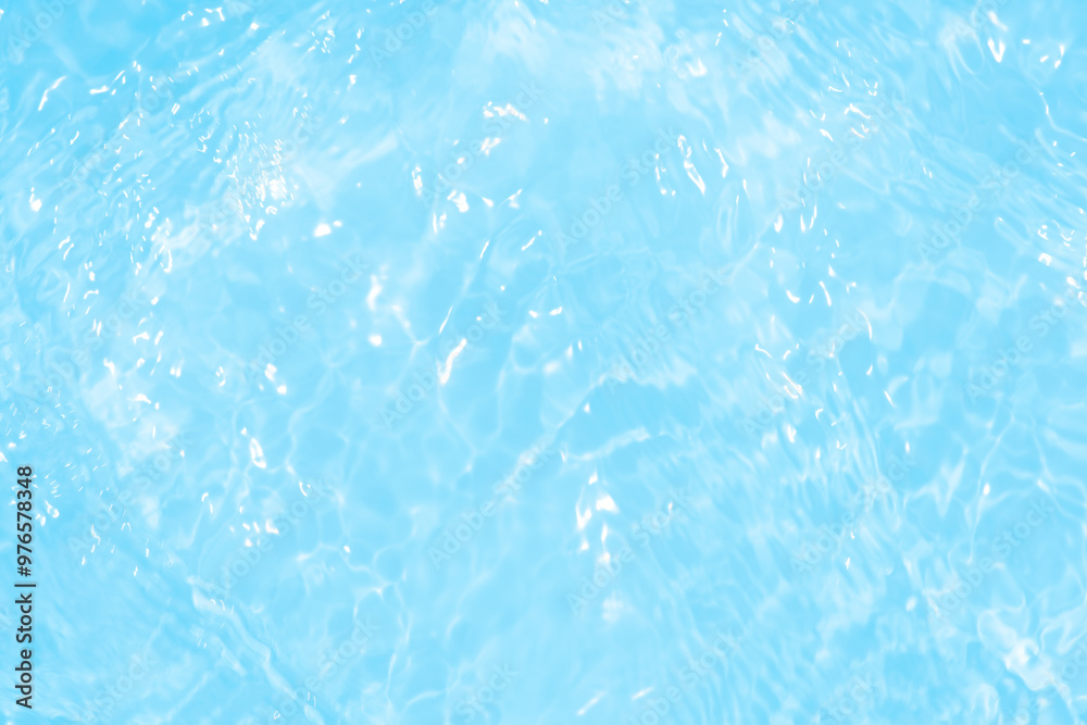 Blue water with ripples on the surface. Defocus blurred transparent blue colored clear calm water surface texture with splashes and bubbles. Water waves with shining pattern texture background. Blue water with ripples on the surface. Defocus blurred transparent blue colored clear calm water surface texture with splashes and bubbles. Water waves with shining pattern texture background.