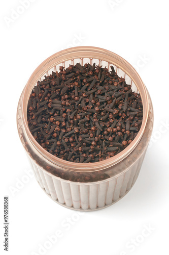 bucket full of dry cloves isolated white background, strong spicy flavor buds used in culinary and traditional medicine, most valued spice native to tropical region photo