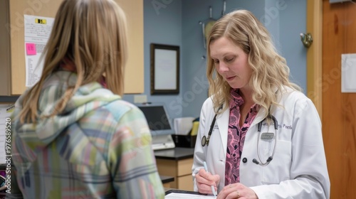 A nurse practitioner writing a prescription for a patient.