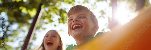 Two children laughing exuberantly while playing outside under the summer sun, capturing a vibrant and carefree moment of childhood enjoyment in a natural setting. photo