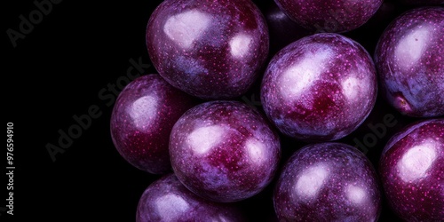 A cinematicstyle photograph of a purple fruit with a glossy smooth surface combined with fruits in shades of deep plum violet and mauve The fruits are tightly packed forming a luxurious rich arrangeme photo