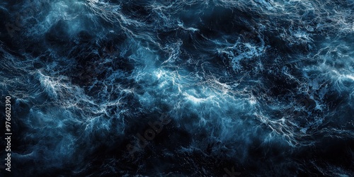 Top view of dark blue ocean wave surface, swirling, abstract.