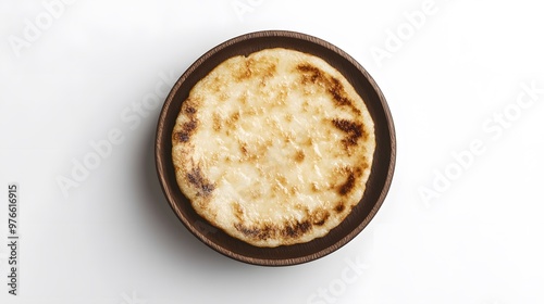 Traditional cheese arepa on wooden plate - simple venezuelan cuisine