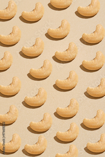 Cashew nuts pattern on beige background is suitable for packaging design, culinary blogs, snack brands, and nutrelated products. photo