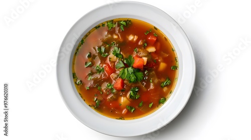 Hearty vegetable soup in white bowl with fresh herbs garnish