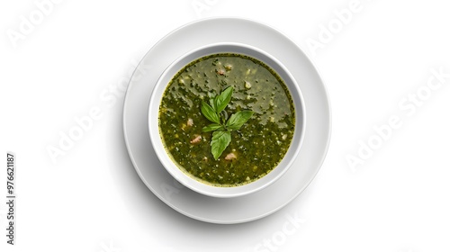 Fresh basil lentil soup in white bowl with herb garnish