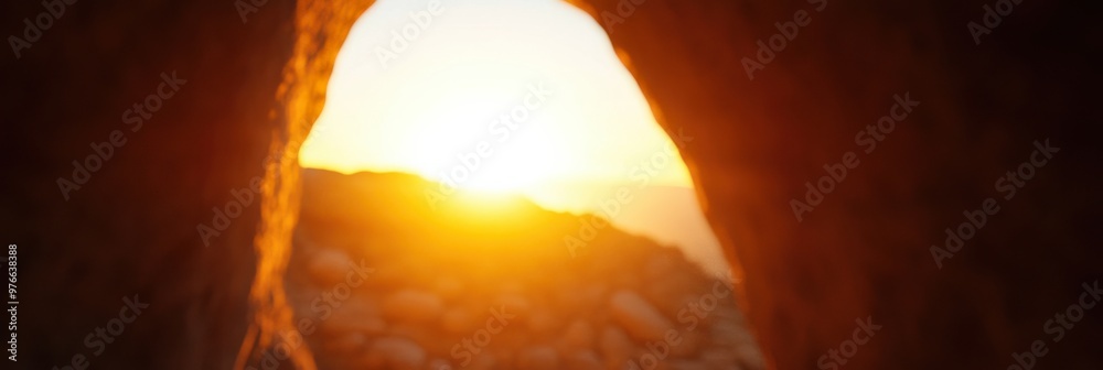 A breathtaking sunrise view captured from inside a cave, looking out toward the horizon, highlighting the beauty of nature's formations and the promise of a new day.
