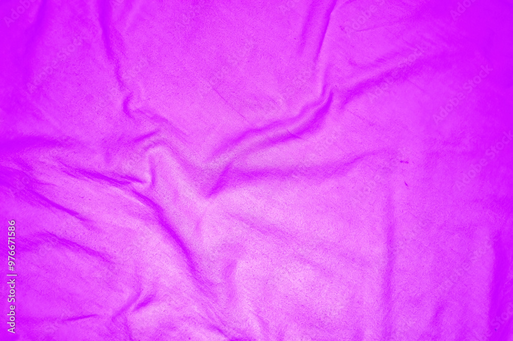 Close up of crumpled purple fabric texture with intricate folds, perfect for backgrounds or textile design.