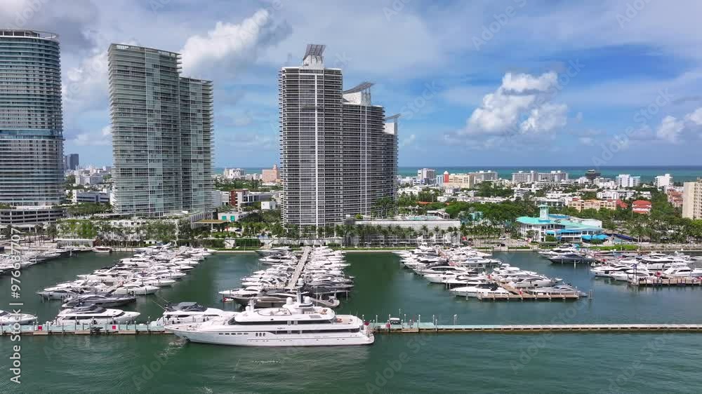 View of Luxury yachts docked at the marina in South Pointe, Miami Beach. Sleek ...