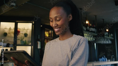 A African manager checking the online orders on the tablet photo