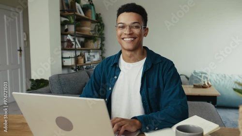 Mixed race professor responding to a students email on a laptop photo