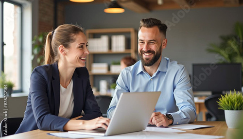 Happy professional business man and woman working on laptop at office meeting, two busy colleagues working together having conversation on project, discussing business plan at office 