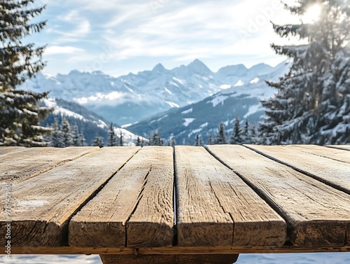Rustic wooden table overlooking a panoramic view of a snowy mountain landscape, showcasing a serene winter scene.