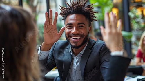 A young man smiles and raises his hand. This image can be used to illustrate concepts like greeting, introduction, and positive energy.