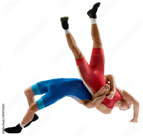 Dynamic shot of two professional Greco-Roman wrestlers in red and blue uniform wrestling against transparent background. Concept of motion, action, combat sports, strength and power, movement, photo