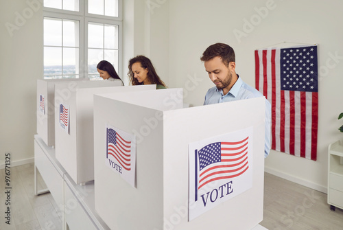 Fotografie American citizens people USA voters standing in a row at polling station at vote center with us flags going to put their ballots in voting booth