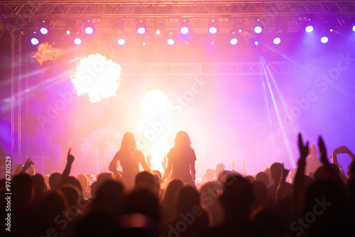 Crowd at concert and colorful stage lights.