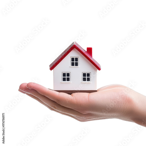 A hand holding a miniature house, symbolizing real estate ownership and the concept of home and security.