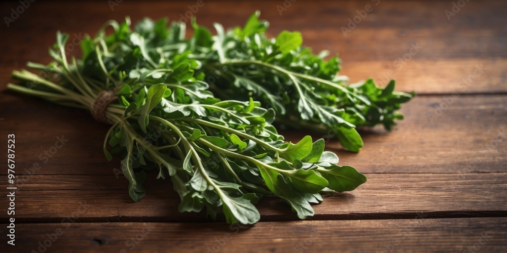 Two Bunches of Arugula on Brown Wooden Background. Two Bunches of Arugula on Brown Wooden Background.