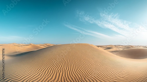 Vast sand dunes stretch across the Sahara Desert in Egypt, showcasing intricate patterns under a brilliant blue sky with soft clouds overhead