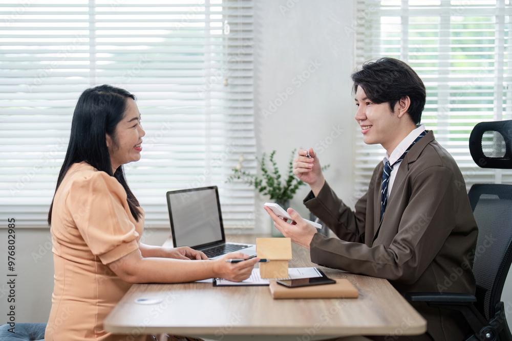 Real Estate Agent Consulting with Client on Property Market Trends for Informed Home Buying Decisions Real Estate Agent Consulting with Client on Property Market Trends for Informed Home Buying Decisions