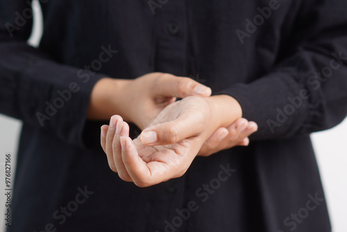 Hand taking radial artery pulse.