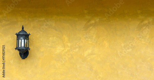 Exterior wall lamp on yellow wall.
