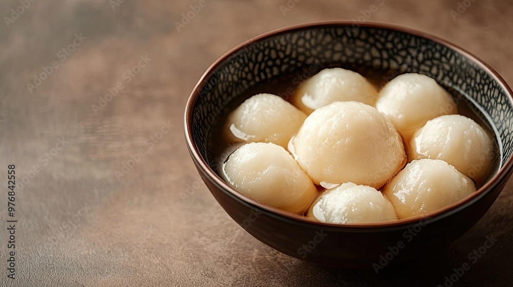 A bowl of rasgulla surrounded by rich syrup, with copy space on the side for promotional text. A bowl of rasgulla surrounded by rich syrup, with copy space on the side for promotional text.