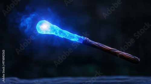 A magical blue wand emitting sparkling light, perfect for fantasy themes and storytelling. photo