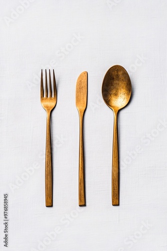 golden cutlery set on white background