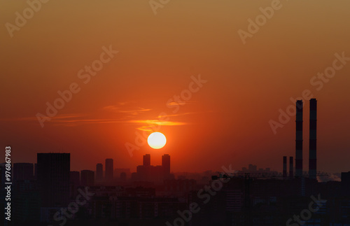 Downtown Sunset Silhouette Panoramic lifetime shot cityscape orange, red, yellow color display in the sky city lots of production and cranes and construction