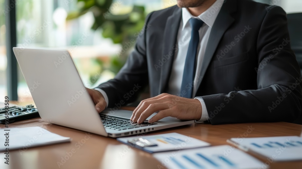 Businessman Working On Laptop With Data Analysis On Desk Businessman Working On Laptop With Data Analysis On Desk