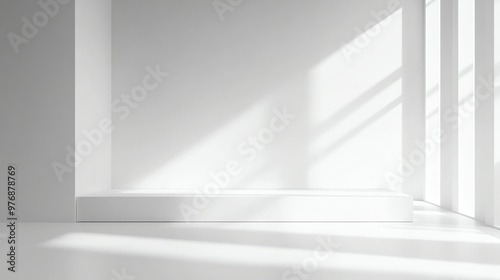 An empty white room with a window and sunlight coming in.
