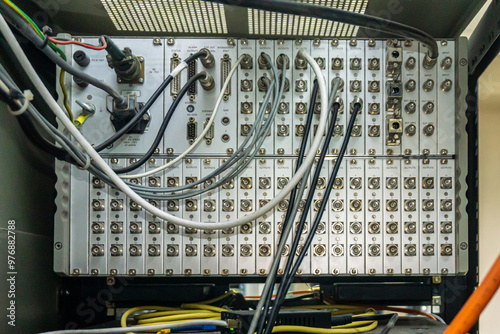 The back of the TV signal reception and distribution unit in the rack. The connected high-frequency cables are visible