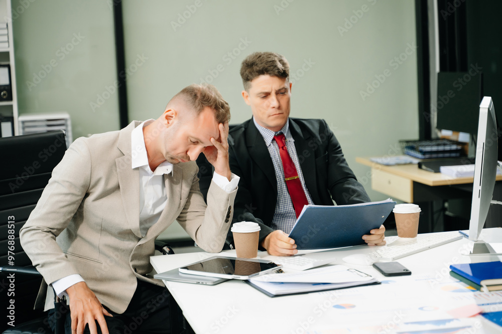 Furious two businesspeople arguing strongly after making a mistake at work Furious two businesspeople arguing strongly after making a mistake at work