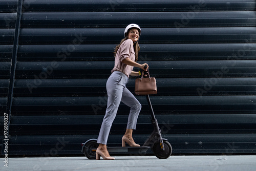 Sexy stylish businesswoman on electric scooter.