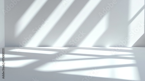 An empty white room with a window and sunlight coming in.
