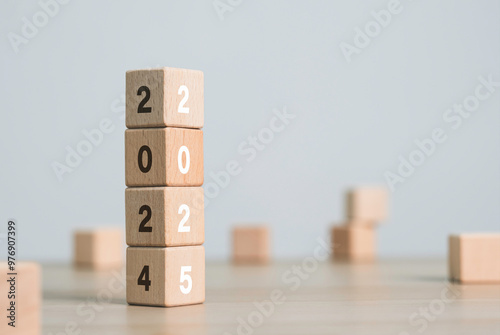 2025 with wooden blocks symbolizing target business for the upcoming year. This represents planning, investment. target and strategy concept.
