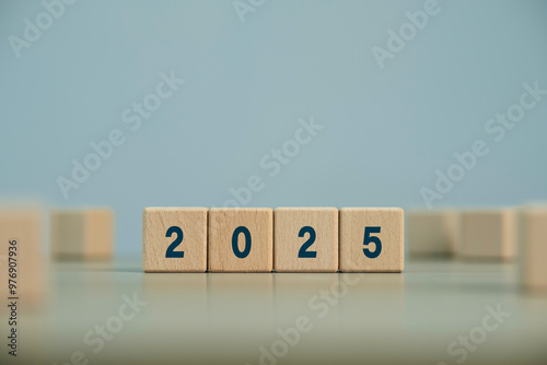 2025 with wooden blocks symbolizing target business for the upcoming year. This represents planning, investment. target and strategy concept.