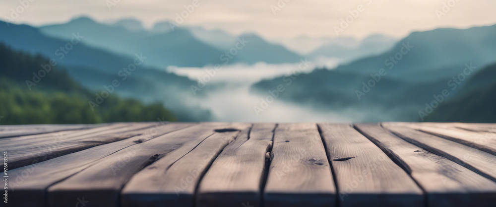 In the misty morning landscape you can admire a wooden table against the backdrop of a blurred mount In the misty morning landscape you can admire a wooden table against the backdrop of a blurred mount